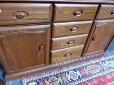 AN ERCOL STYLE ELM SIDEBOARD.