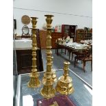 FOUR LARGE BRASS CANDLESTICKS.