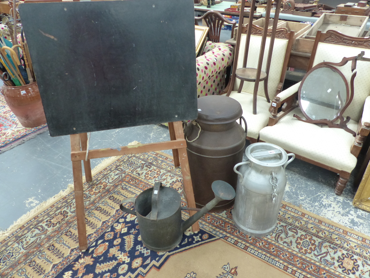 TWO MILK CHURNS, A WATERING CAN AND AN EASEL.