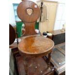 A LATE GEORGIAN MAHOGANY HALL CHAIR WITH PAINTED SHIELD ARMORIAL.