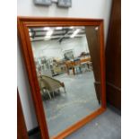 A LARGE PINE FRAMED MIRROR.