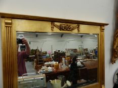 A GILT FRAMED OVERMANTLE MIRROR.