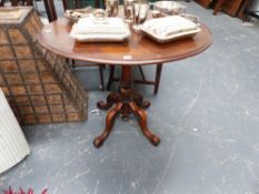 A VICTORIAN MAHOGANY SMALL CENTRE TABLE ON CARVED SHAPED LEGS.