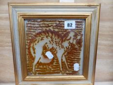 A LUSTRE GLAZED CERAMIC TILE DEPICTING A JACKEL BY JONATHON KINGDON.