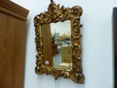 A GILT FRAMED MIRROR.