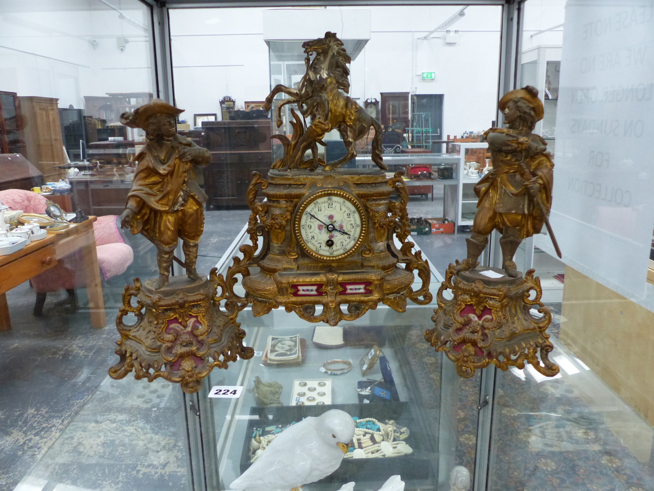 A GILT SPELTER FRENCH CLOCK GARNITURE WITH SEVRES TYPE PORCELAIN PLAQUES.