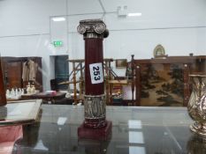 A GRAND TOUR STYLE CANDLESTICK WITH WHITE METAL MOUNT.