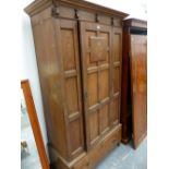 A SHAPLAND & PETTER ARTS AND CRAFTS OAK WARDROBE.