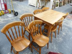 A KITCHEN TABLE AND FOUR SLAT BACK SIDE CHAIRS AND THREE FURTHER SPINDLE BACK SIDE CHAIRS.