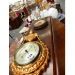 A BAROMETER AND A GLASS DOME ON STAND.