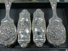 A HALLMARKED SILVER FOUR PIECE DRESSING TABLE SET, DATED BIRMINGHAM 1908.