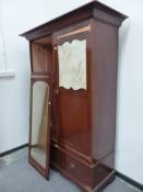 AN EDWARDIAN ART NOUVEAU STYLE MAHOGANY WARDROBE.