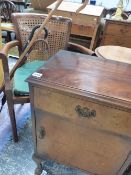 A BEDSIDE CABINET AND TWO ARMCHAIRS.