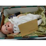 AN ORIENTAL BISQUE HEAD DOLL TOGETHER WITH A FURTHER BISQUE HEAD BABY DOLL.