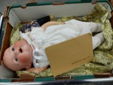 AN ORIENTAL BISQUE HEAD DOLL TOGETHER WITH A FURTHER BISQUE HEAD BABY DOLL.