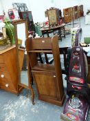 A CHEVAL MIRROR AND A SMALL BOOKCASE.