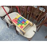 A CHILD'S BRICK TROLLEY WITH BRICKS.