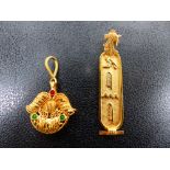 A YELLOW METAL CARTOUCHE PENDANT TOGETHER WITH ONE OTHER.