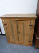 A SMALL ANTIQUE PINE CUPBOARD.