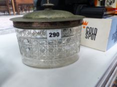 A CUT GLASS BISCUIT BARREL WITH HINGED EPNS LID.