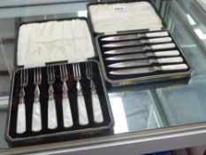 TWO CASED CUTLERY SETS WITH MOTHER OF PEARL HANDLES.