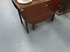 A LARGE MAHOGANY DROP LEAF DINING TABLE.