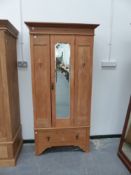 A SMALL OAK WARDROBE.