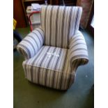 AN UPHOLSTERED ARMCHAIR.