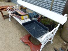 A PAINTED GARDEN BENCH WITH CAST IRON ENDS.