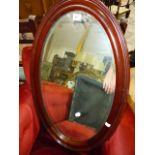 AN EDWARDIAN OVAL WALL MIRROR.