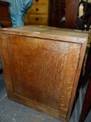 A SMALL OAK CABINET.