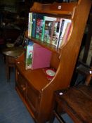 A SMALL ERCOL WATERFALL BOOKCASE.
