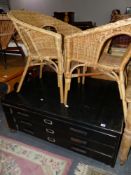 A THREE DRAWER PLAN CHEST AND TWO RATTAN CHAIRS.