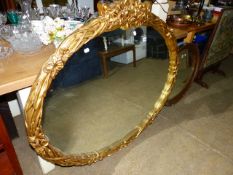 A LARGE GILT FRAMED MIRROR.