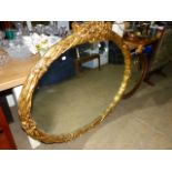 A LARGE GILT FRAMED MIRROR.