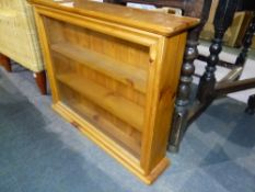 A PINE DISPLAY CABINET.