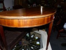 A PAIR OF MAHOGANY DEMI LUNE TABLES.