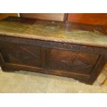 A CARVED OAK PANEL COFFER.