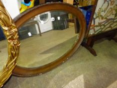 AN EDWARDIAN OVAL MIRROR.