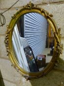 A GILT FRAMED MIRROR AND A WALNUT FRAMED MIRROR.