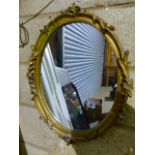 A GILT FRAMED MIRROR AND A WALNUT FRAMED MIRROR.