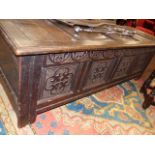 AN 18th.C.AND LATER OAK LARGE COFFER WITH FOUR PANEL TOP CARVED FOUR PANEL BASE. W.158cms.