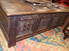 AN 18th.C.AND LATER OAK LARGE COFFER WITH FOUR PANEL TOP CARVED FOUR PANEL BASE. W.158cms.