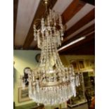 A NEOCLASSICAL STYLE BRASS FRAME CRYSTAL HUNG CHANDELIER OF WATERFALL FORM WITH SIX LIGHTS. H.