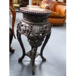 A CHINESE MARBLE TOP CARVED HARDWOOD STAND, ROUND WITH PIERCED APRON. H.67cms.