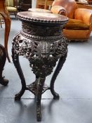 A CHINESE MARBLE TOP CARVED HARDWOOD STAND, ROUND WITH PIERCED APRON. H.67cms.