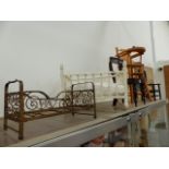 AN ANTIQUE IRON DOLL'S BED, THREE DOLL'S CHAIRS, A ROCKING CRADLE AND A SMALL PAINTED BIRDCAGE