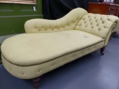 A VICTORIAN MAHOGANY SCROLL ARM CHAISE LONGUE WITH RING TURNED TAPERED LEGS ENDING IN CASTORS. L.