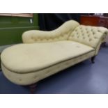 A VICTORIAN MAHOGANY SCROLL ARM CHAISE LONGUE WITH RING TURNED TAPERED LEGS ENDING IN CASTORS. L.