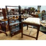 A MAHOGANY GEORGIAN STYLE DRESSING STOOL TOGETHER WITH A SMALL WATERFALL TYPE HANGING SHELF. (2)